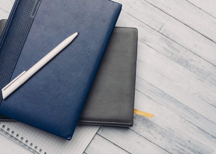 desktop notepad and documents office wooden background top view. High quality photo